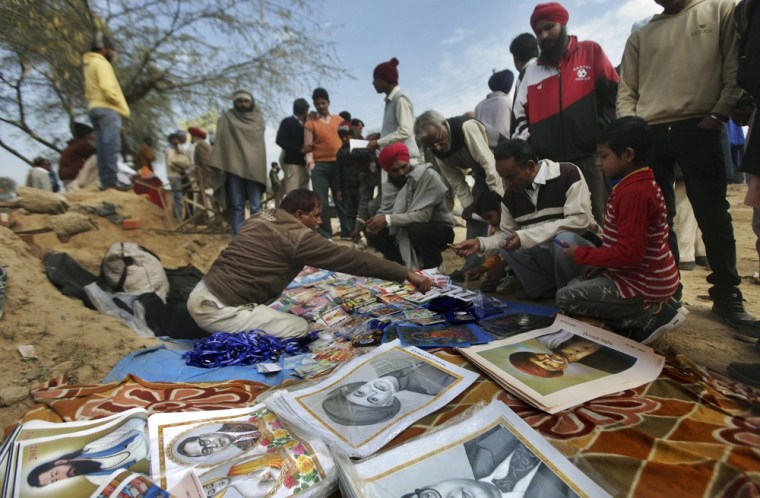Image: An Indian roadside vendor sells portraits of Dalit leaders and other items before the start of an election rally