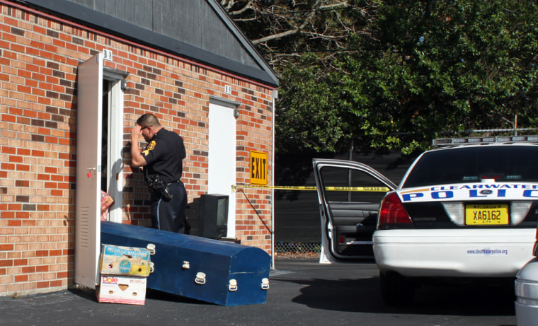 Police investigate the discovery of a body in a rented storage unit on Thursday afternoon at U-Stor Self Storage.