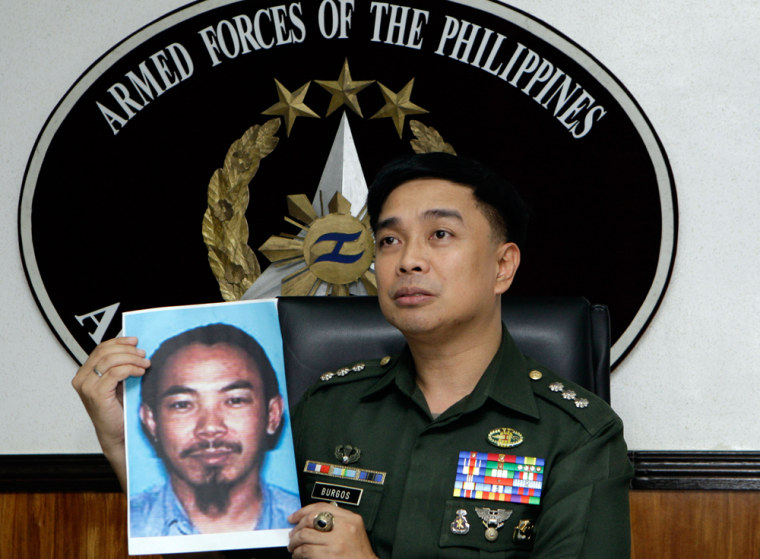 Image: Armed Forces of the Philippines spokesman Col. Marcelo Burgos shows a picture of Malaysian Zulkipli bin Hir, also known as Marwan, a top leader of the regional, al Qaida-linked Jemaah Islamiyah terror network