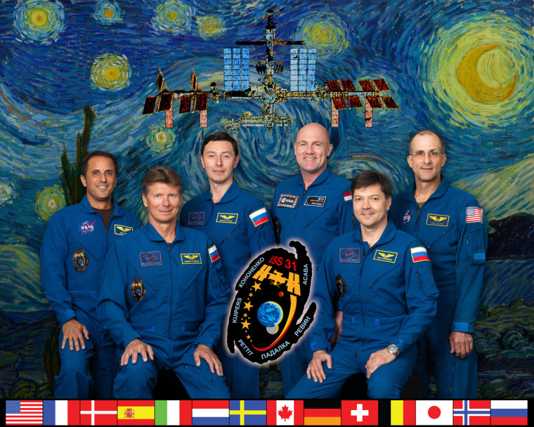 Astronauts pose in front of Starry Night painting