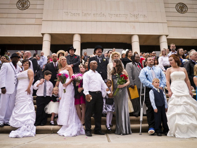 Image: 96 couples gather on the steps of the Arizona Supreme Court for their mass wedding ceremony on Valentine's Day in Phoenix