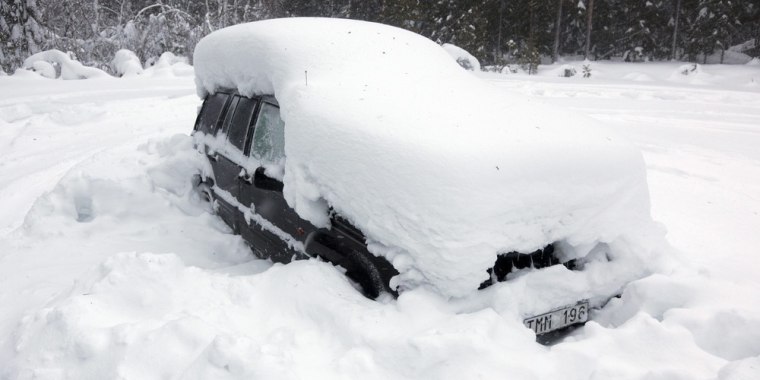 Image: A snowed-in car is seen in the woods north of Umea