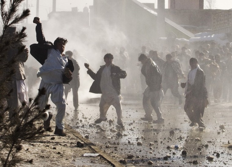 Image: Afghan protesters throw rocks towards a water canon near a U.S. military base in Kabul