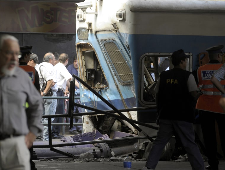 Image: Police and rescue workers surround a train that crashed at Once train station in Buenos Aires