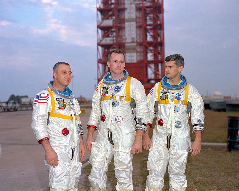 From left, Apollo 1 astronauts Virgil I. "Gus" Grissom, Edward White and Roger Chaffee pose in front of their Saturn 1 launch vehicle at Launch Complex 34 at the Kennedy Space Center. The astronauts later died in a fire on the pad.