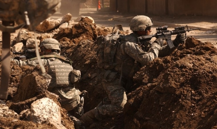 Soldiers occasionally get a sixth sense feeling about battlefield dangers. Here, Sgt. Auralie Suarez and Pvt. Brett Mansink take cover during a firefight with anti-Iraqi forces in the Al Doura section of Baghdad, Iraq.
