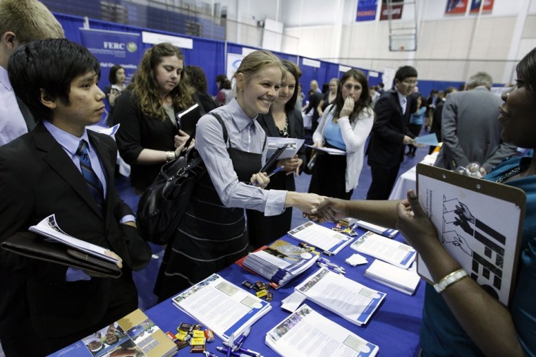 Image: American University student Daukste shakes hands with recruiter Nava-Martinez during a career job fair in Washington