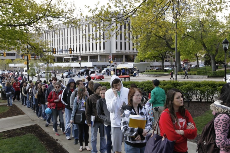Image: Students and faculty line up with visitors to get through a security checkpoint  to enter the Cathedral of Learning on the University of Pittsburgh campus, on Tuesday, April 10.
