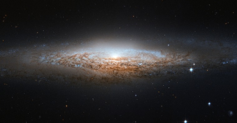 NGC 2683 is a spiral galaxy seen almost edge-on, giving it the shape of a science fiction spaceship.