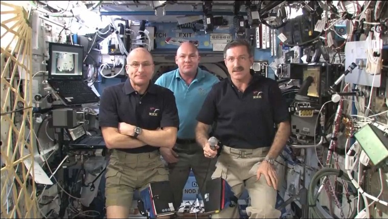 Expedition 30 commander Dan Burbank, flight engineer Don Pettit (left) and European Space Agency flight engineer Andre Kuipers (center) aboard the International Space Station on April 11. For Burbank and Pettit, today is tax day.