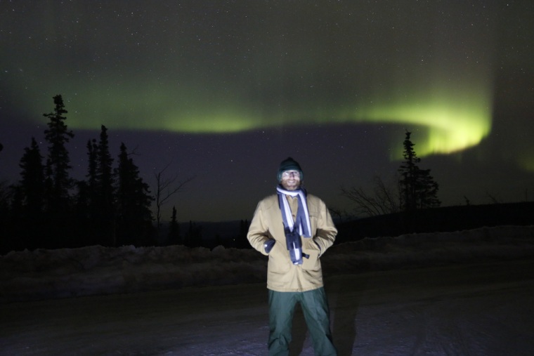 Alaska's northern lights dance behind Space.com reporter Mike Wall in this photo taken April 11 on the slopes of Murphy Dome mountain.