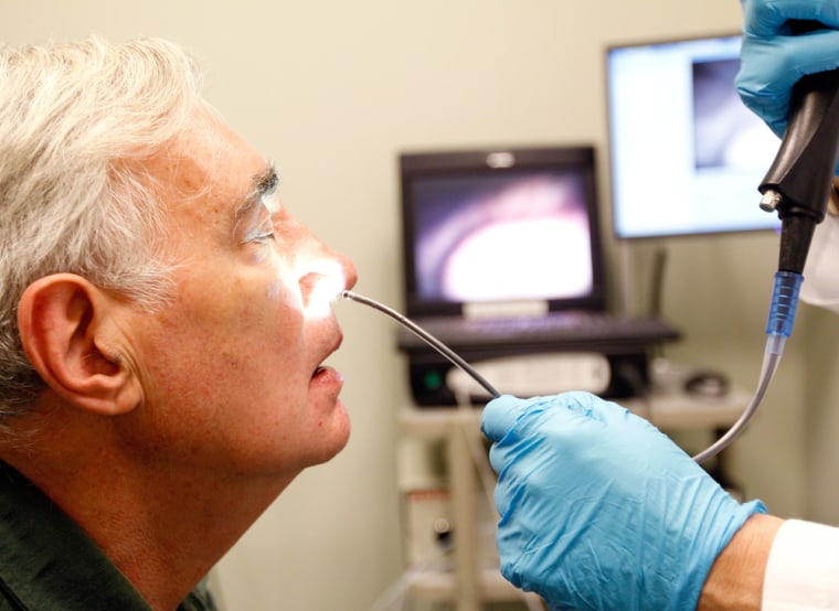 Image: Dr. Jonathan Aviv prepares to scope a patient