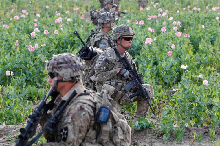 Image: US and Afghan soldiers patrol in Zharay district in Kandahar province, southern Afghanistan