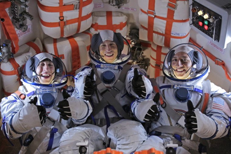 Veteran NASA astronaut Mike Massimino (right) poses for a photo with "The Big Bang Theory" actor Simon Helberg and another actor during a break from filming the season finale of CBS' Big Bang Theory.