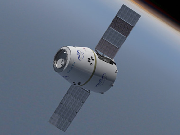 The Dragon space capsule with its solar panels deployed.