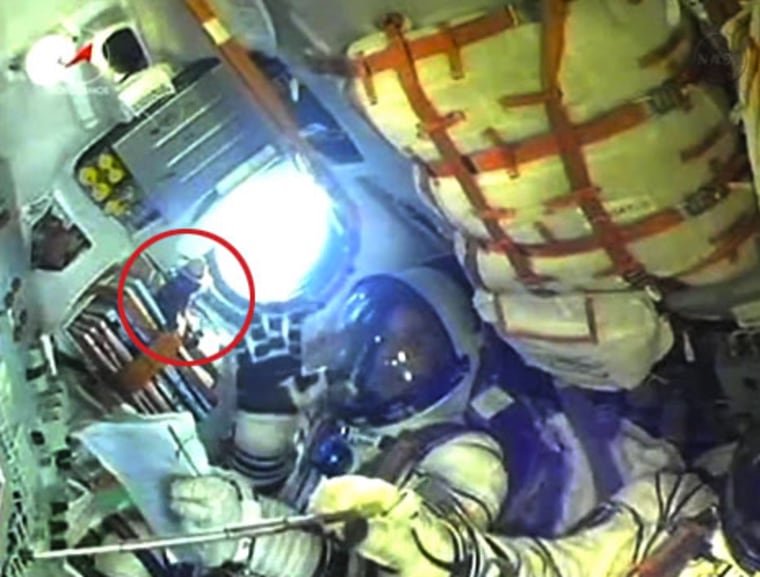 Circled in red, the Smokey Bear talisman and "zero-g indicator" is seen near NASA astronaut Joe Acaba on board Soyuz TMA-04M. Acaba launched with cosmonauts Gennady Padalka and Sergei Revin to the International Space Station on Monday night.