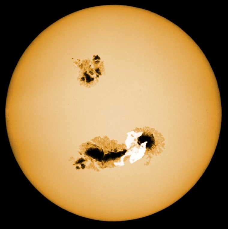 This is an artistic rendition of a "superflare star". It has large starspots (much larger than those on the sun) and a superflare (white region) occurs near the starspots.
