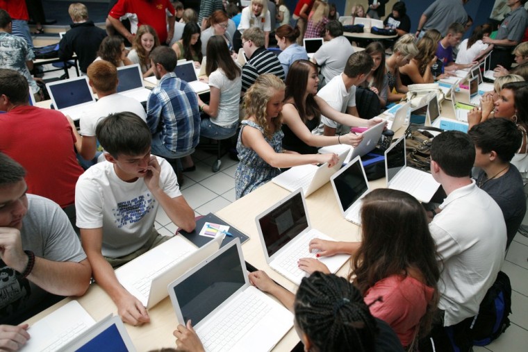 Image: Students set up their donated laptop computers on the first day of school at Joplin High School in Joplin