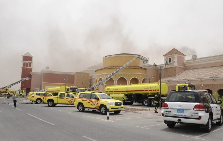 Image: Firefighters attempt to extinguish a fire at the Villagio Mall in Doha