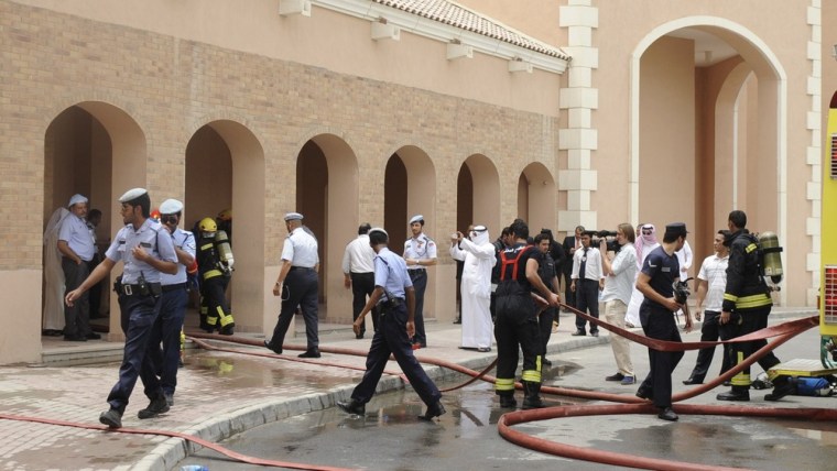 Image: Firefighters work to put out a fire at the Villagio Mall in Doha