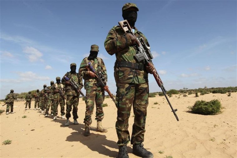 Image: Members of Somalia's Al Shabaab militant group parade during a demonstration to announce their integration with al Qaeda, in Elasha, south of the capital Mogadishu February 13, 2012. Picture taken February 13, 2012.
