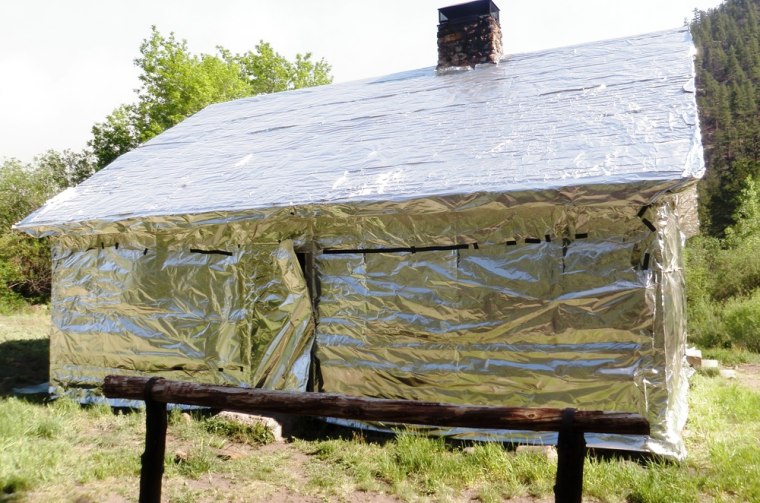Image: Log cabin wrapped in aluminum material