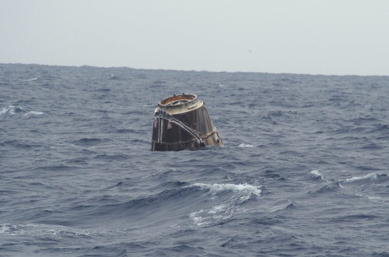 SpaceX's first Dragon capsule to visit the International Space Station bobs in the Pacific Ocean after a successful splashdown that capped its successful test flight on Thursday. The capsule landed off the coast of Baja California.