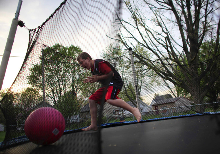 Image: Parker Roos, who suffers from Fragile X, plays on a trampoline in his backyard at his home in Canton, Illinois.