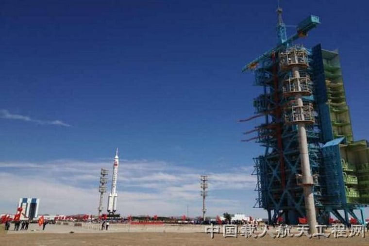 A Long March 2F rocket carrying the Shenzhou 9 rocket rolls out to the launch pad at China's Jiuquan Satellite Launch Center ahead of a planned June 2012 launch of the country's first manned space docking mission.