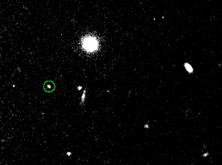 Image of S/2010 J 1 (circled), a 1.8-mile-wide moon of Jupiter discovered in September 2010. It is hanging around with an even smaller moon.
