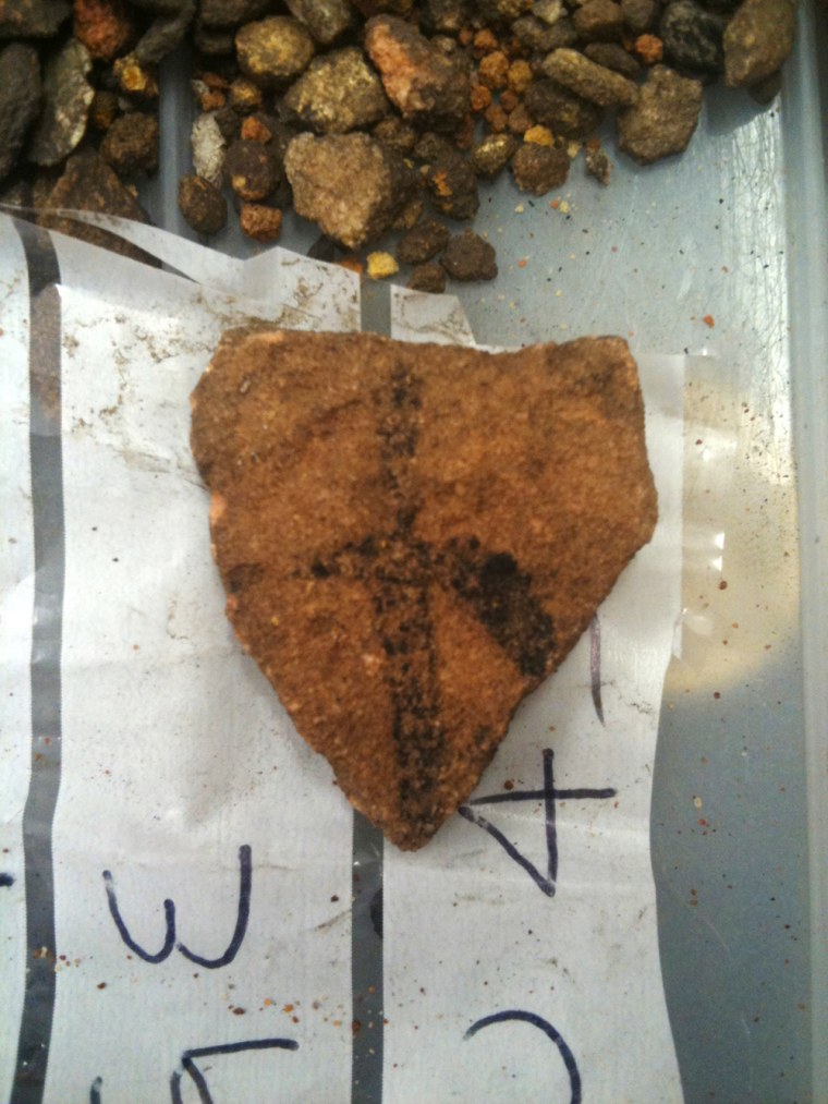 A fragment of Aboriginal rock art on granite found in Australian Outback is seen on a plastic bag. University of Southern Queensland archaeologist Bryce Barker said Monday, June 18, 2012 that tests show the Aboriginal rock art in the cave was made 28,000 years ago, making it the oldest in Australia and among the oldest in the world. The rock art was made with charcoal, so radiocarbon dating could be used to determine its age. 