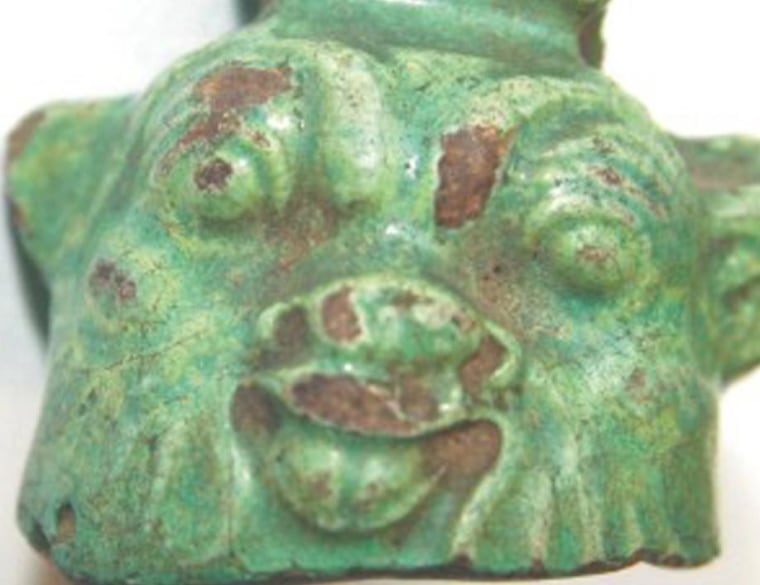 Bes, a dwarf god and protector of young children and pregnant women, is depicted in this faience bell from the first millennium B.C.