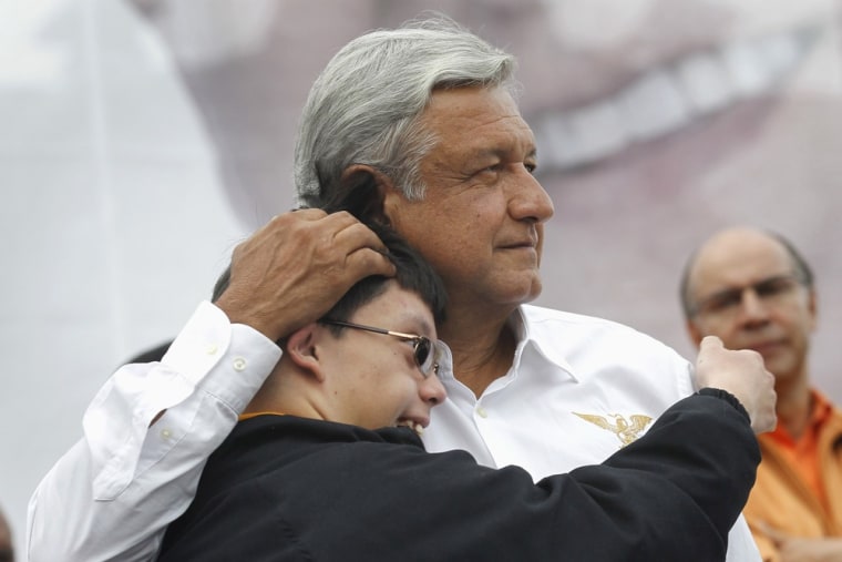 Image: Andres Manuel Lopez Obrador, presidential candidate for the Party of the Democratic Revolution (PRD), hugs a boy during a rally in Toluca