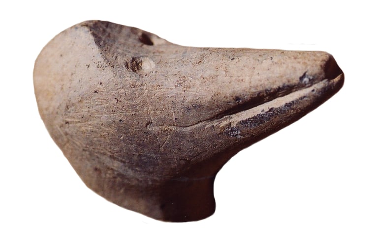 A woodpecker pipe effigy, about 5 cm across. When you smoke the pipe do you become the woodpecker? That's one idea behind artifacts like this. Photo courtesy Archaeological Services Inc.