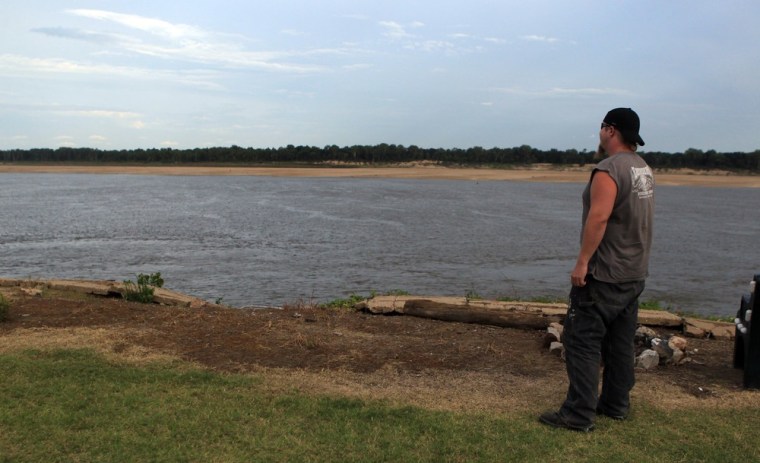 Image: Jesse Stater looks out at the low water at Tom Sawyer's Mississippi River RV Park, in West Memphis, Arkansas.
