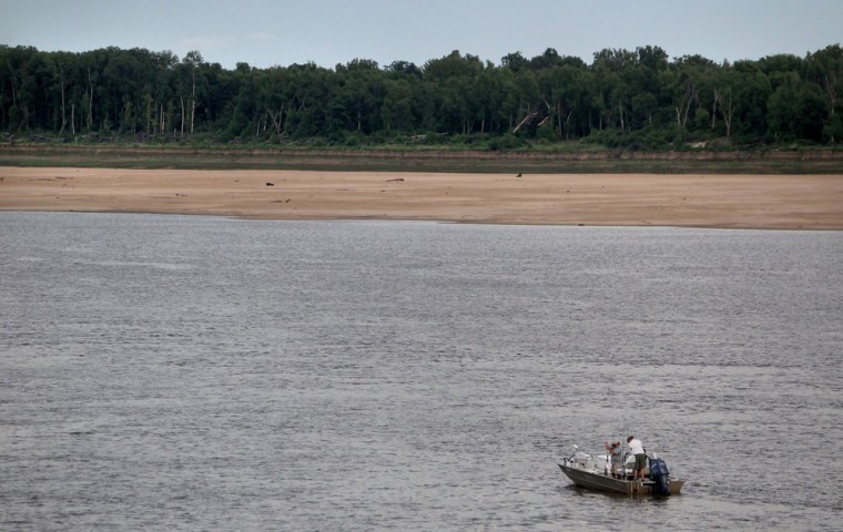 Image: Men fish off the sandy banks of Tom Sawyer's Mississippi River RV Park, in West Memphis, Arkansas