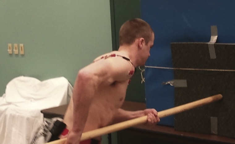 Image: Volunteer performs a spear-thrusting task