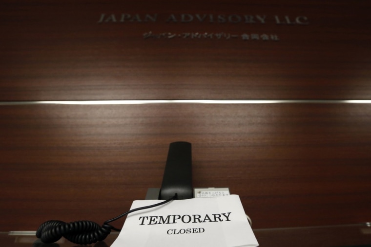 Image: Notice is seen at a closed office of Japan Advisory in Tokyo