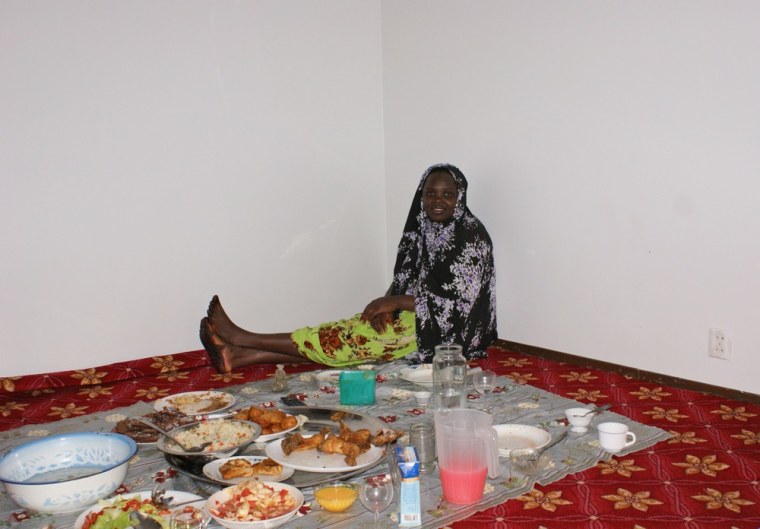 Image: Kaltouma Abakar, a refugee from Sudan's Darfur province, sits on the floor of her living room.