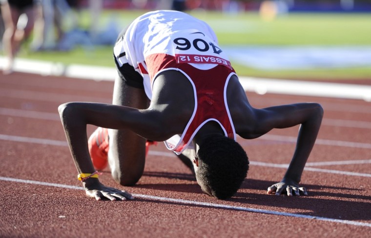 Image: Mohammed Ahmed prays after winning the men's 10,000 metre race at the Canadian Track and Field Olympic Trials in Calgary