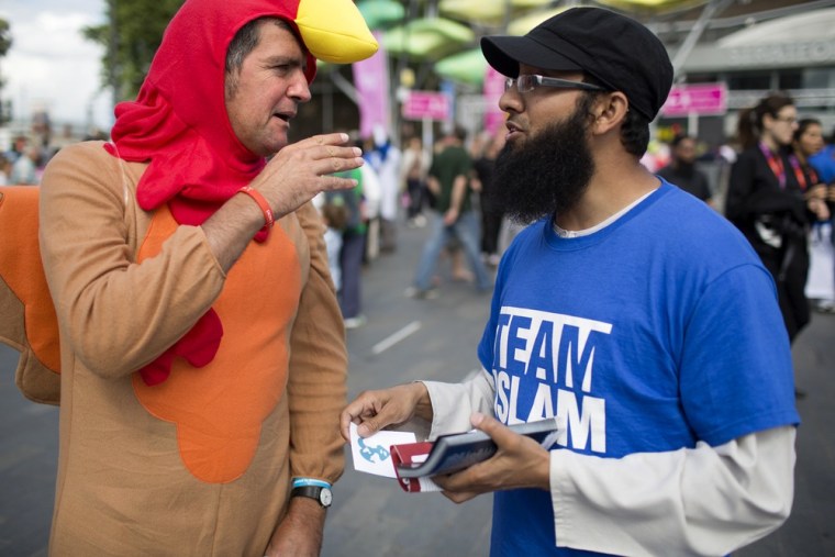 Image: Vegan Antonino Buonamico, dressed as a turkey, discusses whether eating meat is a good or bad thing with Isa (no last name given) of Team Islam.