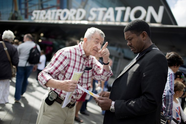 Image: Pointing the way to salvation, George Chaplin, left, shares his Christian Scientist beliefs with passerby Barry McCalla outside Straford Bus Station.