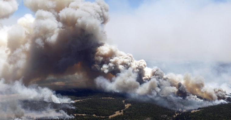 Image: Miles of smoke billow skyward from the Wallow Fire Tuesday, June 7, 2011, near Greer, Ariz.