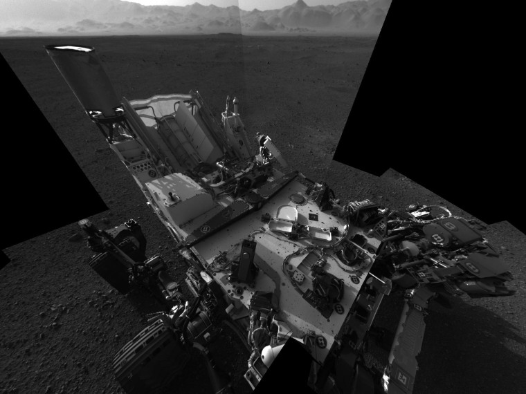 This high-resolution mosaic of 20 images is the first clear self-portrait of NASA's Mars rover Curiosity on the Red Planet. The rear of the rover is at top, with two right-side wheels on the left. The rim of Gale Crater forms the lighter-color strip of the background. Images taken on Aug. 8 EDT.