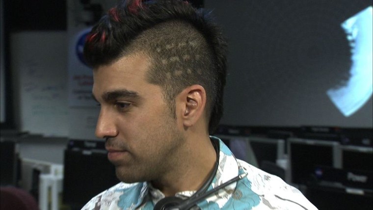 NASA rocket scientist Bobak Ferdowsi, who gained fame with his red, white and blue Mohawk, now has had the Morse code for J-P-L cut into this hairdo, in tribute to the Jet Propulsion Laboratory and Curiosity’s Morse-code wheel track.