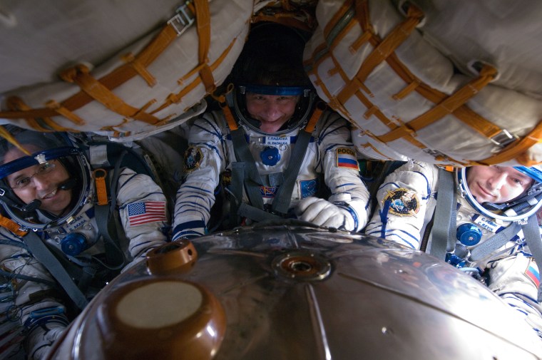 Astronauts Gennady Padalka, Joe Acaba, Sergei Revin inside Soyuz 30 craft