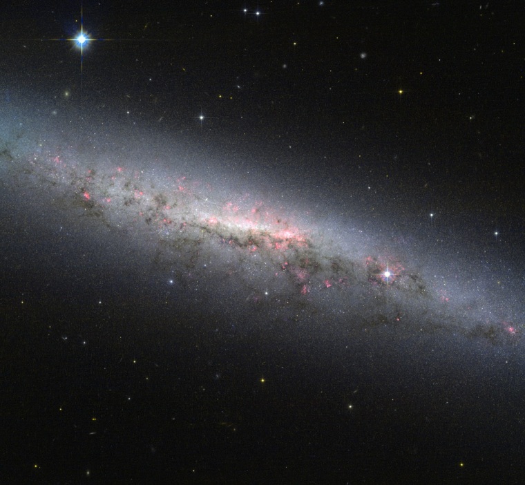 This shot from the Hubble Space Telescope shows an edge-on view of the star-forming galaxy NGC 7090, which is located about 30 million light-years from Earth.