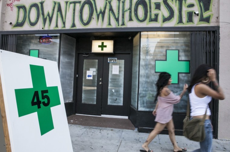 Image: Pedestrians walk past a medical marijuana dispensary in the Echo Park area of Los Angeles.