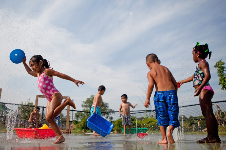 Image: Preschoolers play in fountains during their designated water-play time at Educare in Omaha, Neb., on Aug. 3, 2012.