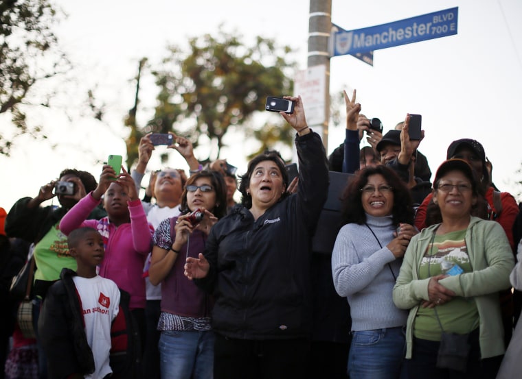 Image: People cheer and take pictures of Endeavour